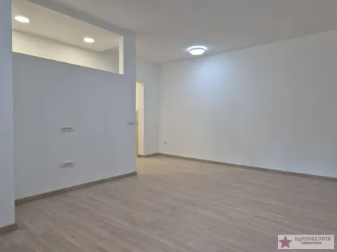 Empty bright room with laminate flooring and white walls. - image 6