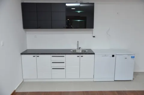 Modern kitchen with white and black cabinets. - image 8