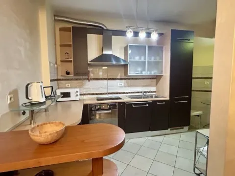 Modern kitchen with wooden elements and built-in appliances. - image 3