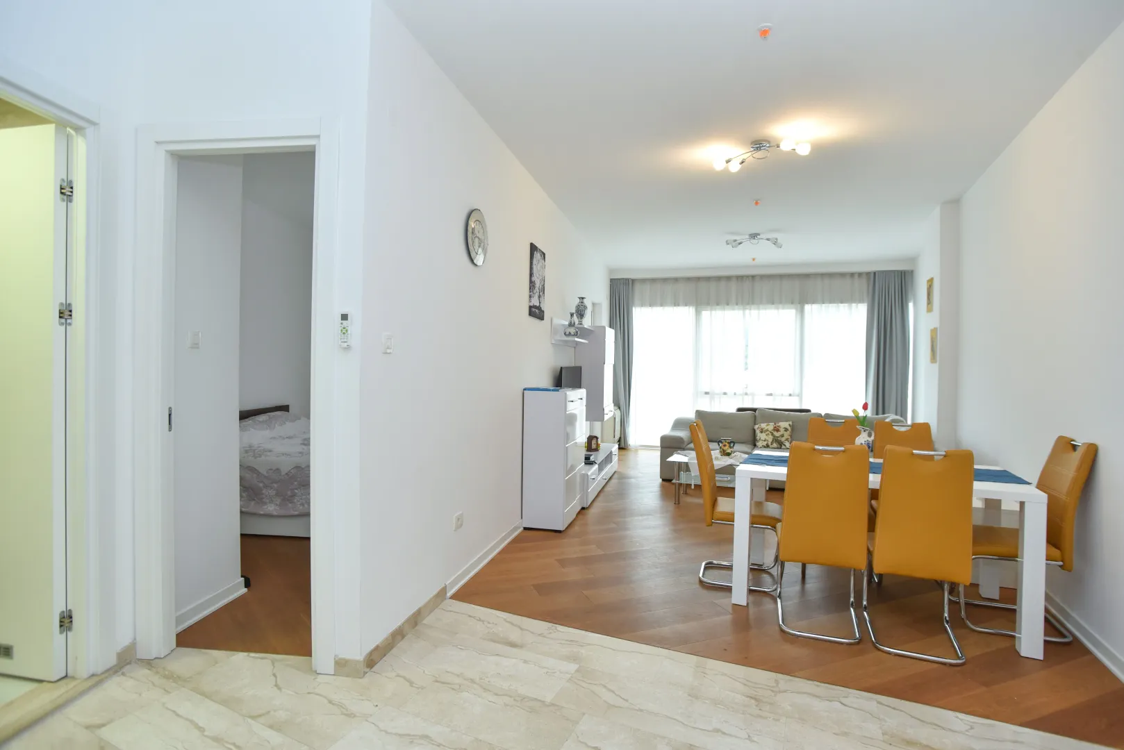 Spacious living room with a dining area and a view of the sofa.