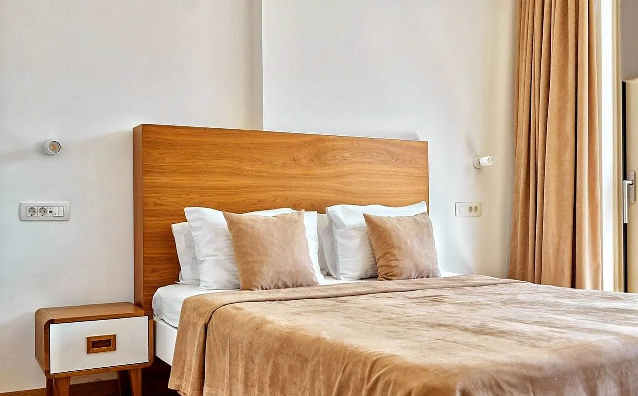 Bedroom with a double bed and wooden headboard.