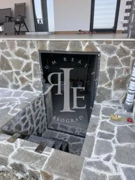 View of the exterior stone-clad basement entrance. - image 38
