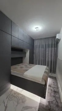 Modern bedroom with built-in wardrobes and a bed. - image 6