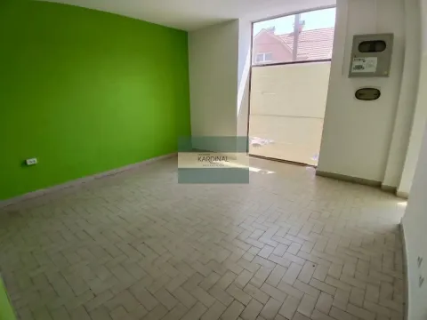 Empty room with light tiled flooring and one green wall. - image 4