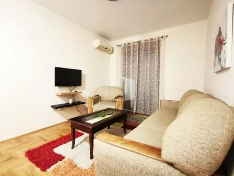 Living room with a sofa set, coffee table, and wall-mounted TV. - image 3
