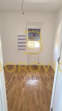 Empty room with parquet flooring and a single window. - image 4