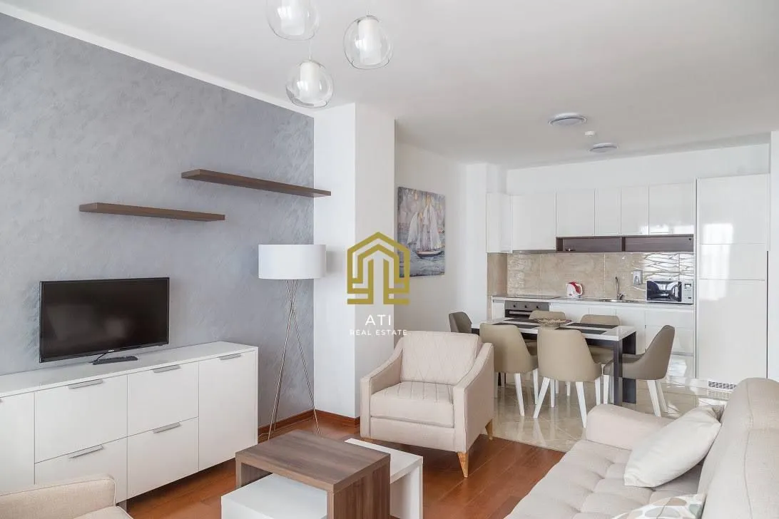Living room with dining area and open-plan kitchen.