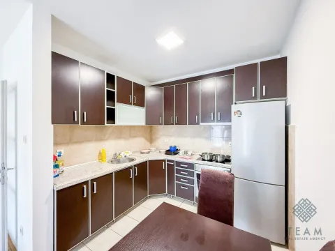 Kitchen with dark wooden cabinetry and a white refrigerator. - image 7