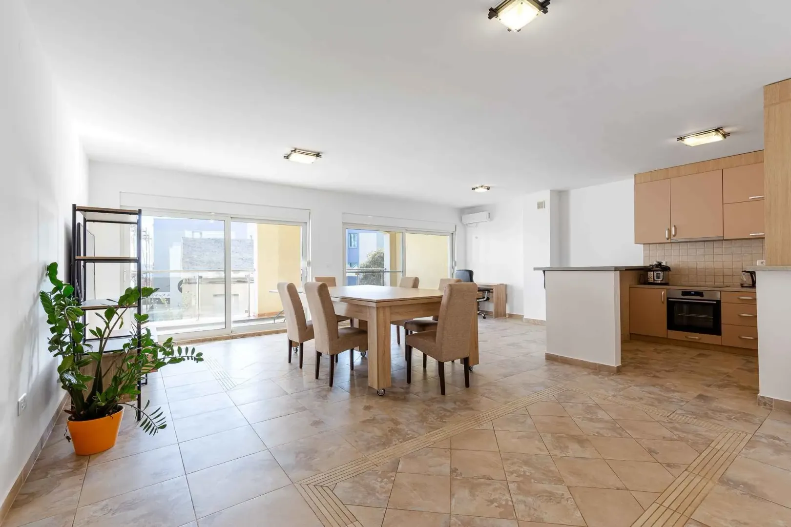 Open-plan space with a kitchen, dining area, and access to the terrace.