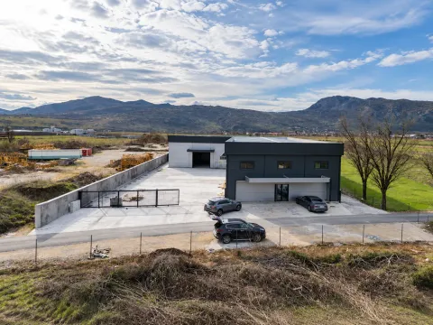 Aerial view of a modern commercial building with a warehouse and courtyard. - image 3