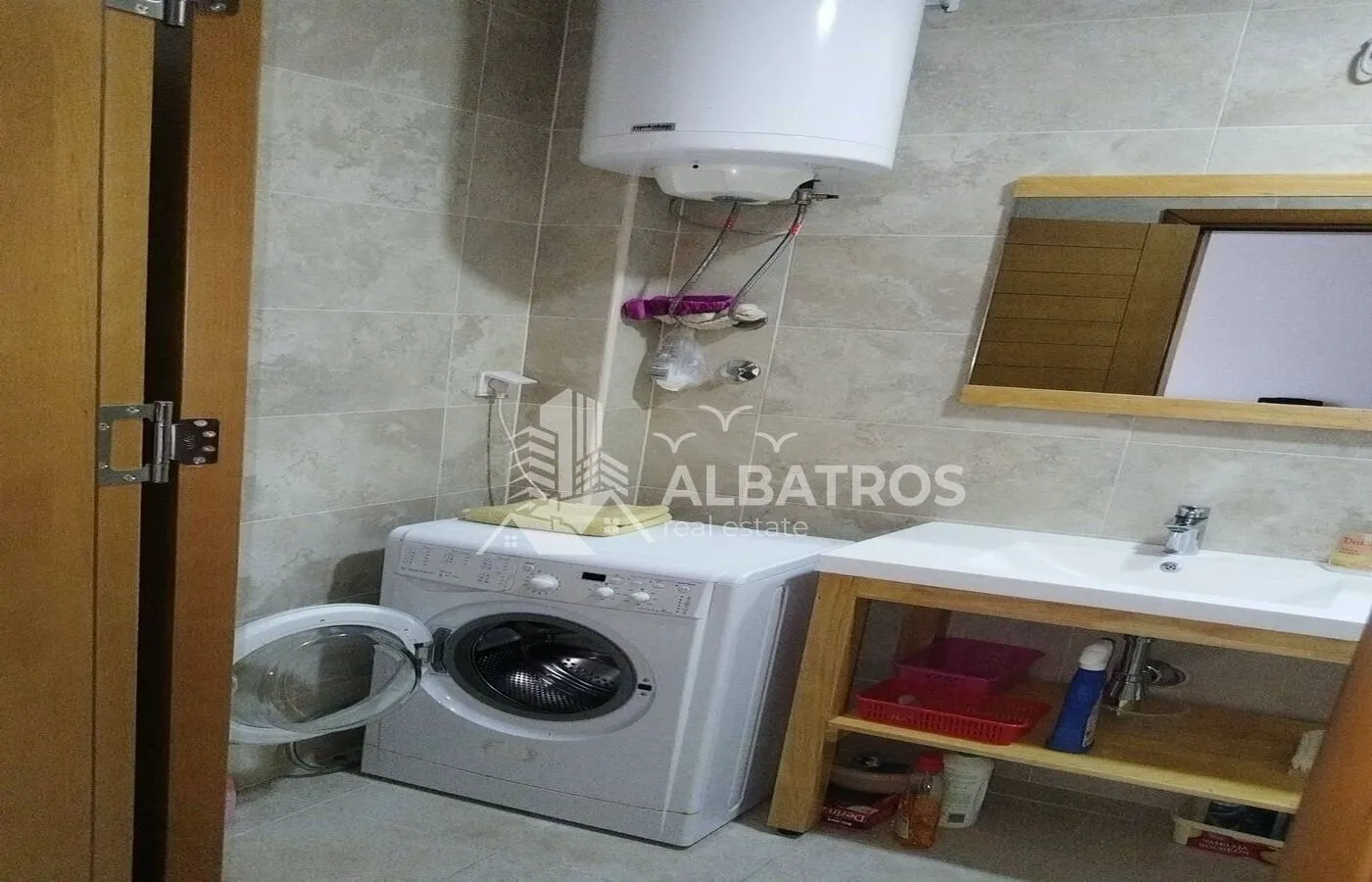 Bathroom with a washbasin, washing machine and a wall boiler.