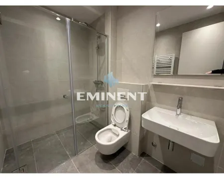 Modern bathroom with a walk-in shower, washbasin, and toilet. - image 12