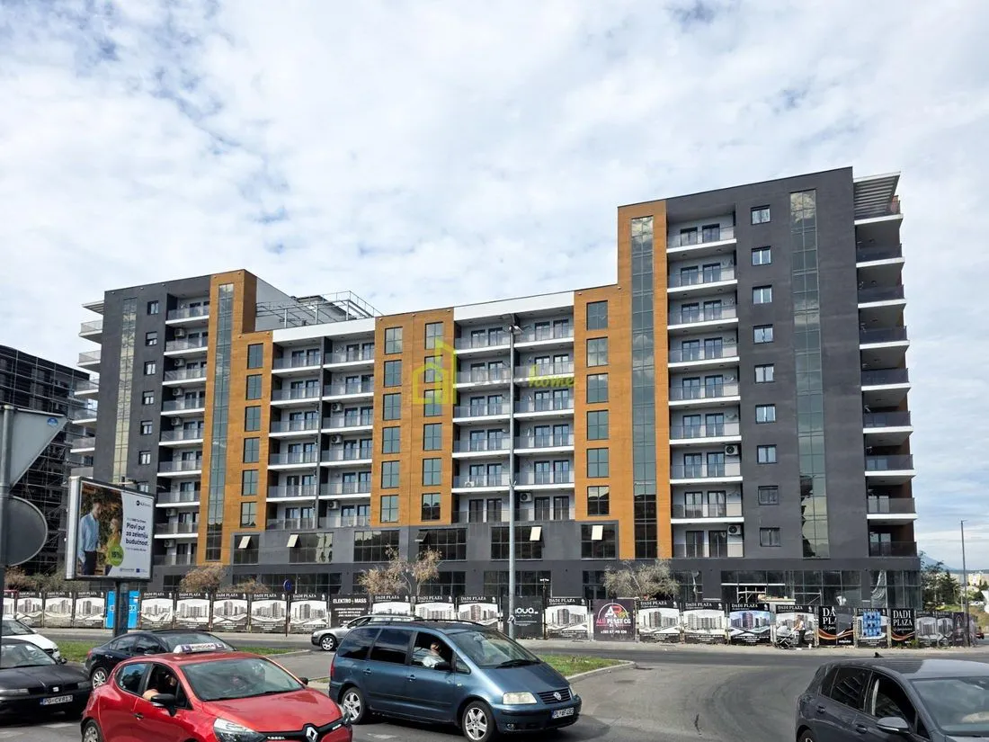 Exterior view of a modern residential building with large windows and balconies.