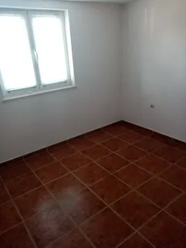 Empty room with white walls, a window, and tiled flooring. - image 37