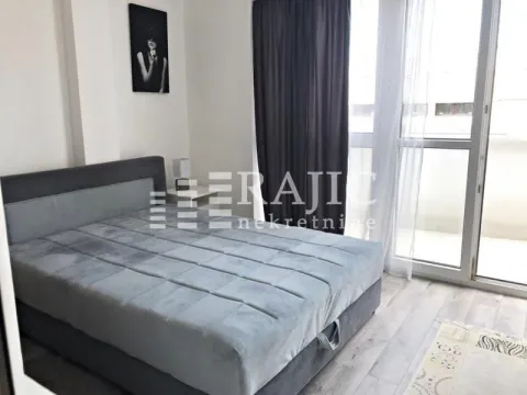 Furnished bedroom with a double bed and terrace access. - image 8