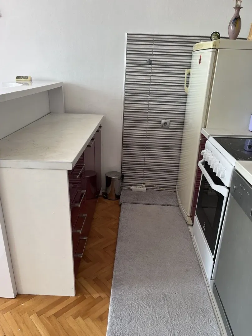 Small kitchen with cabinets and appliances.