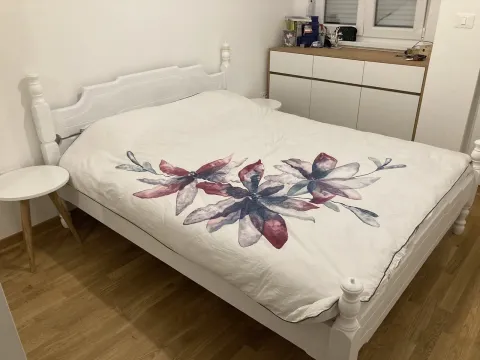 Bright bedroom with a white double bed and a dresser. - image 4