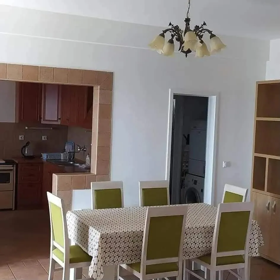 Dining area with a table and chairs, overlooking the kitchen.