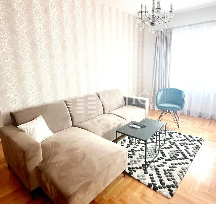 Furnished living room with a sectional sofa, coffee table, and armchair.