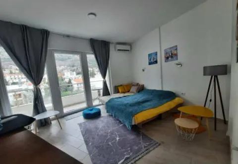 Bright bedroom with a bed, floor lamp, and access to the terrace. - image 12
