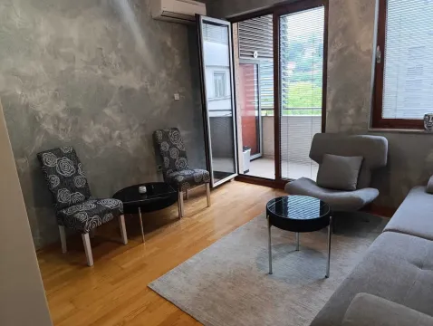 Living room with a sofa set, armchair, and access to the terrace. - image 2