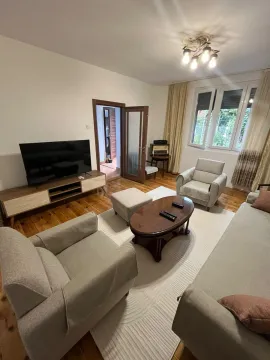 Living room with sofa set, coffee table, and TV. - image 15