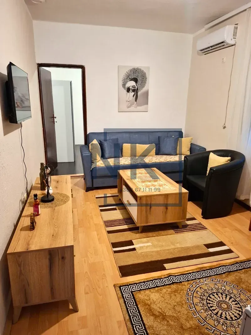 Living room with sofa, coffee table and television.