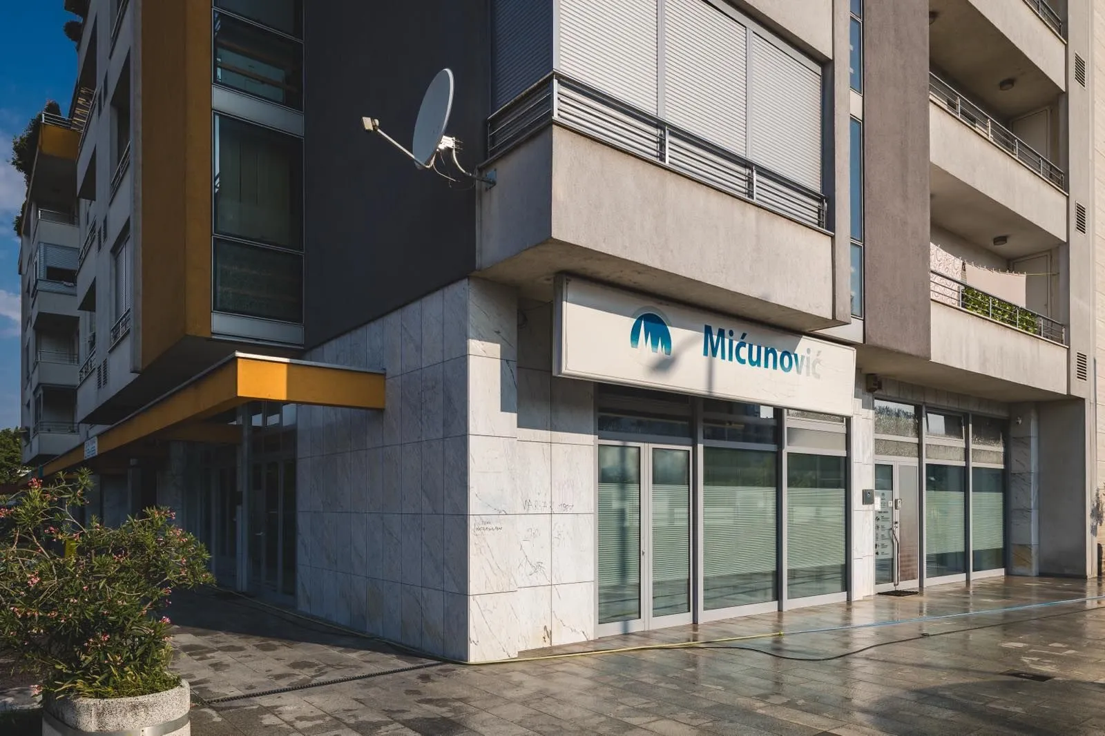 View of the exterior of a commercial space on the ground floor of a residential building.