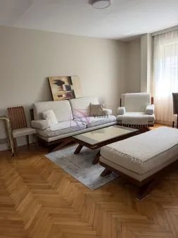 Living room with a sofa set, armchair, coffee table, and parquet flooring. - image 2