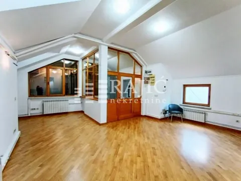 Spacious empty room with wooden flooring and sloped ceiling. - image 7