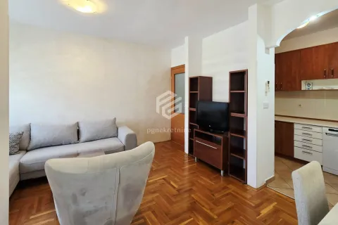 Living room with sofa and a view towards the kitchen. - image 3