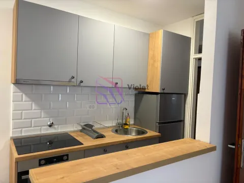 Small modern kitchen with grey cabinetry and wooden countertops. - image 2