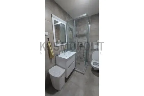 Modern bathroom with a shower cabin, washbasin, and toilet. - image 7