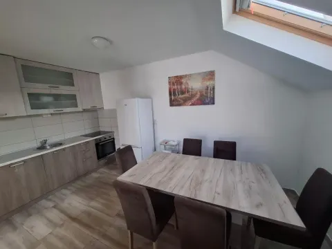 Kuhinja sa trpezarijom i drvenim elementima u potkrovlju. - image 6
