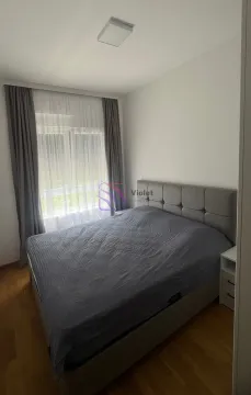 Bedroom with a double bed and a window with curtains. - image 6