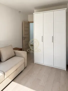 Small bedroom with a sofa bed and a large white wardrobe. - image 14