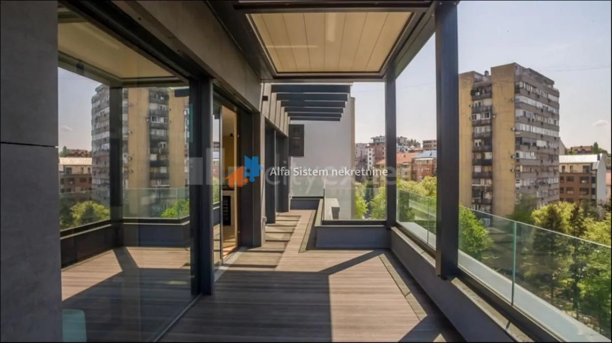 Spacious covered terrace with wooden flooring and a city view.