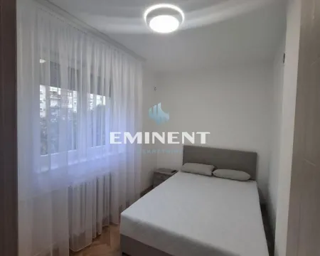 Small bedroom with a double bed and a window covered with a white curtain. - image 7
