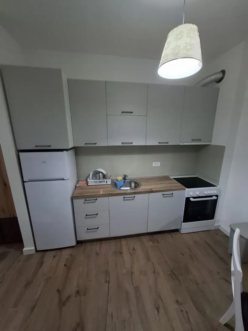 Smaller kitchen with grey cabinets and built-in appliances.