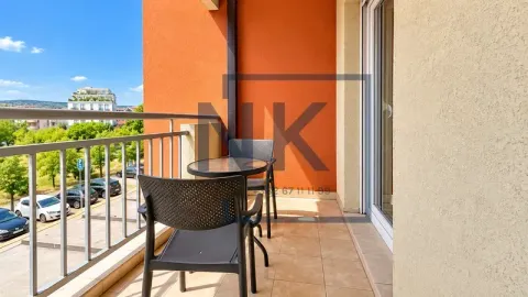 Furnished balcony with a table and chairs and a view of the surroundings. - image 18