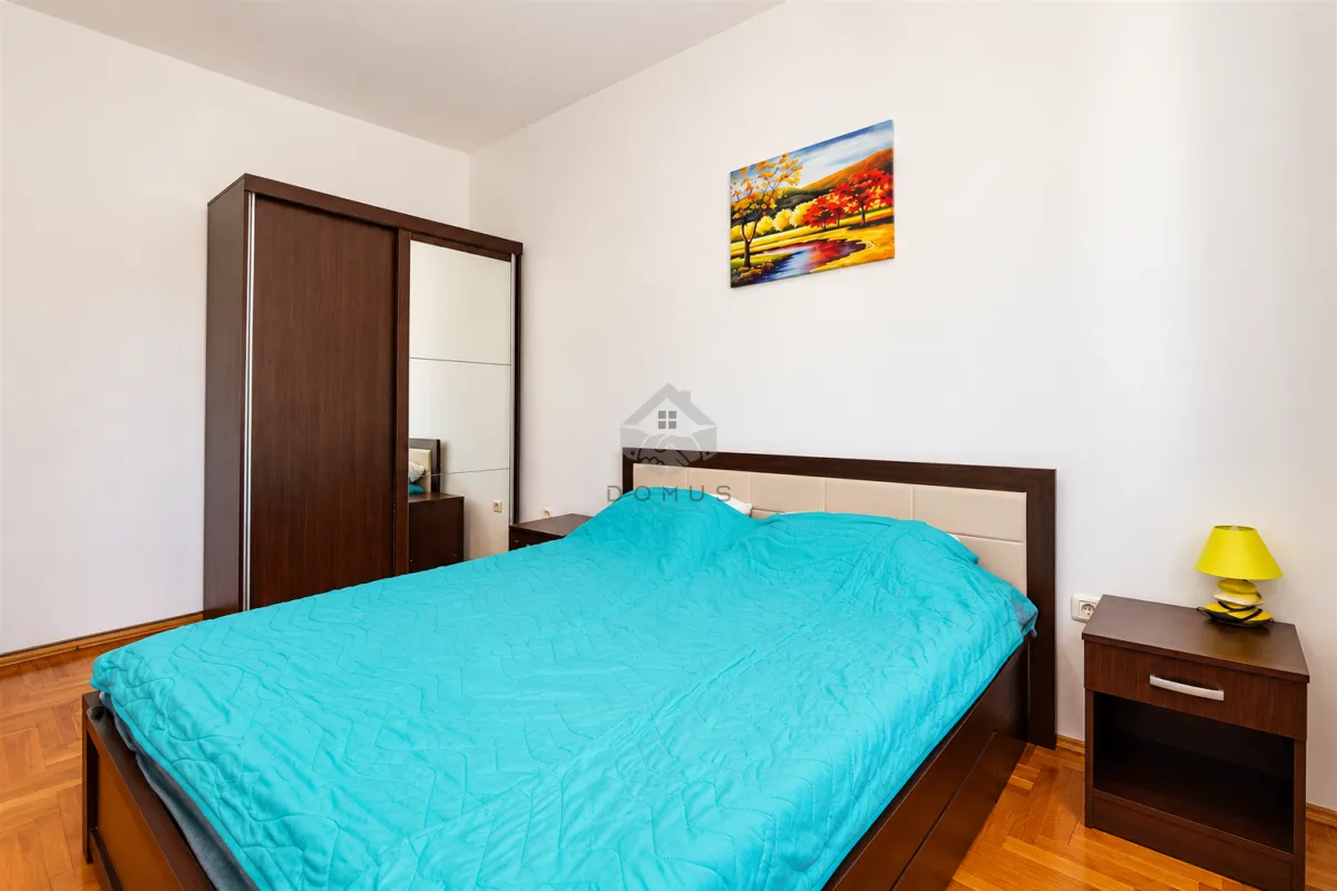 Bedroom with a double bed, wardrobe, and bedside table.