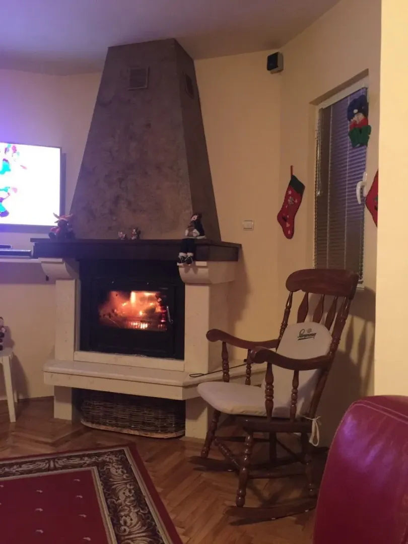 Living room featuring a fireplace and a rocking chair.