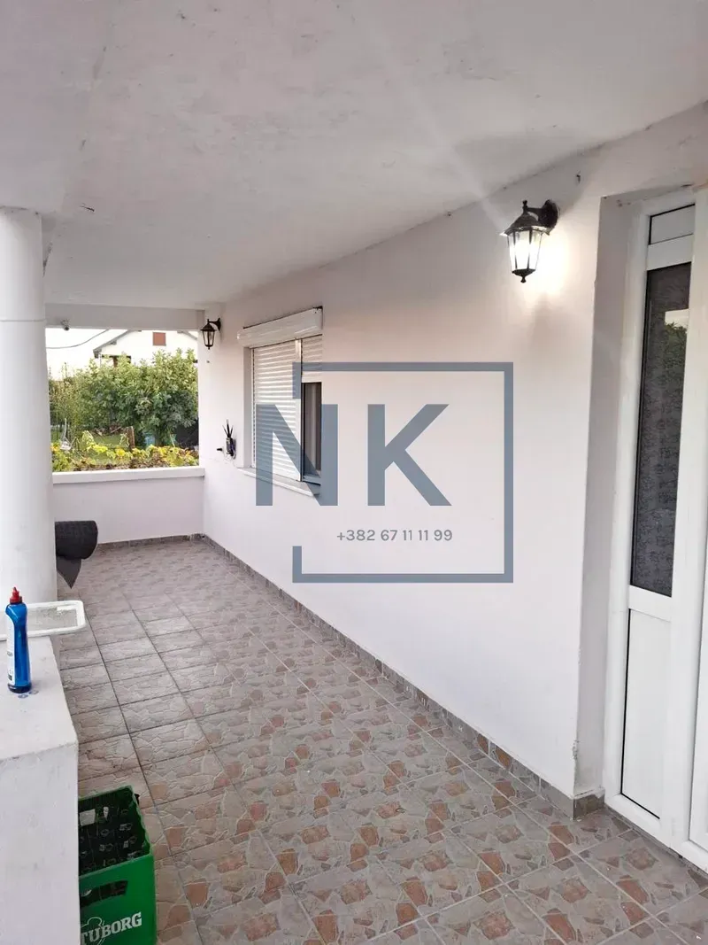 Covered terrace with tiled flooring and an entrance door.