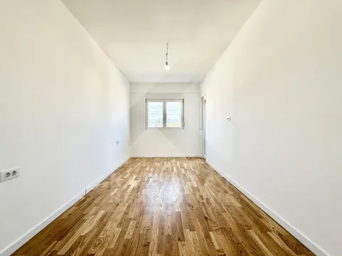 Empty room with wooden parquet flooring and white walls. - image 4