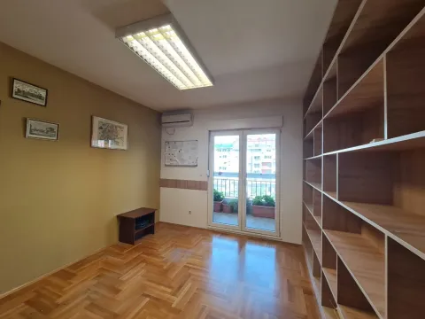 Bright empty room with wooden parquet flooring and a large shelving unit. - image 10