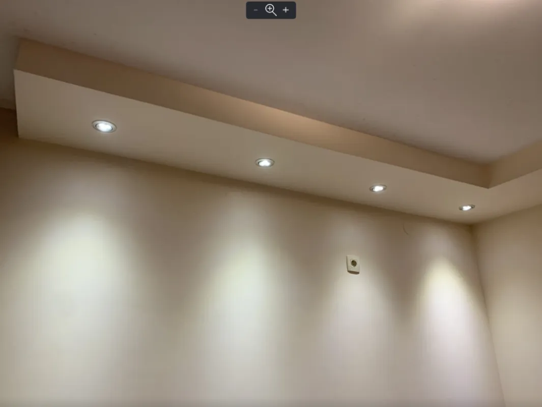 Detail with recessed lighting on the ceiling and wall.