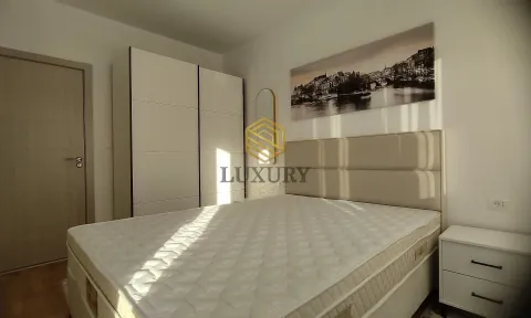 Modern bedroom with a double bed, wardrobe, and a wall painting. - image 3