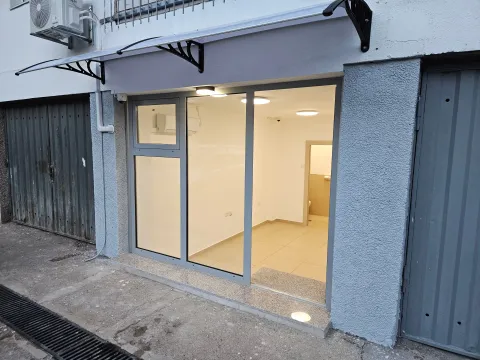 Exterior of the commercial space with a large glass storefront and entrance door. - image 2