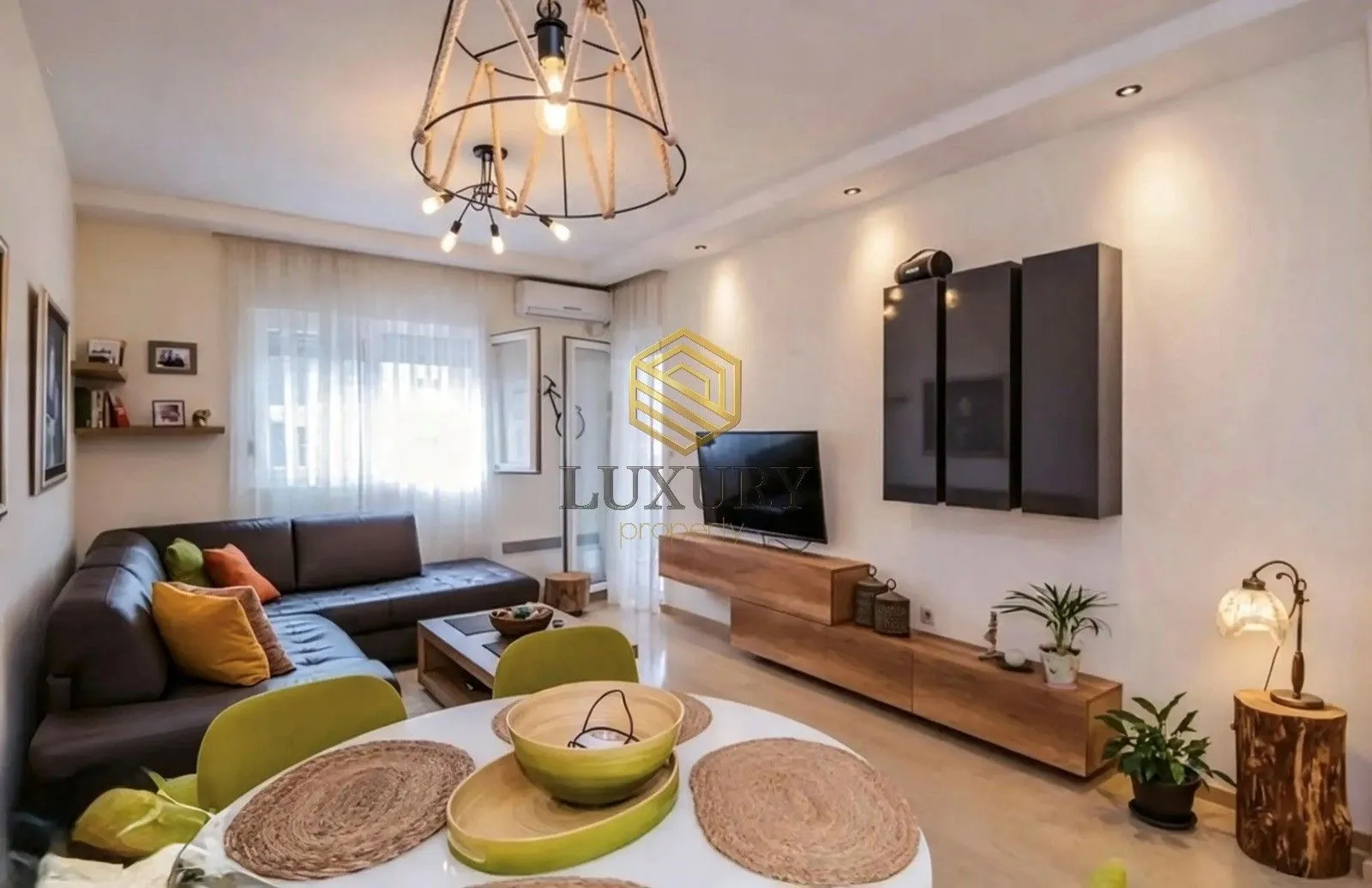 Modern living room with a sofa, dining table, and decorative lighting.