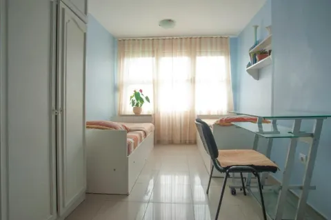 Furnished children's bedroom with two beds, a desk, and a wardrobe. - image 8